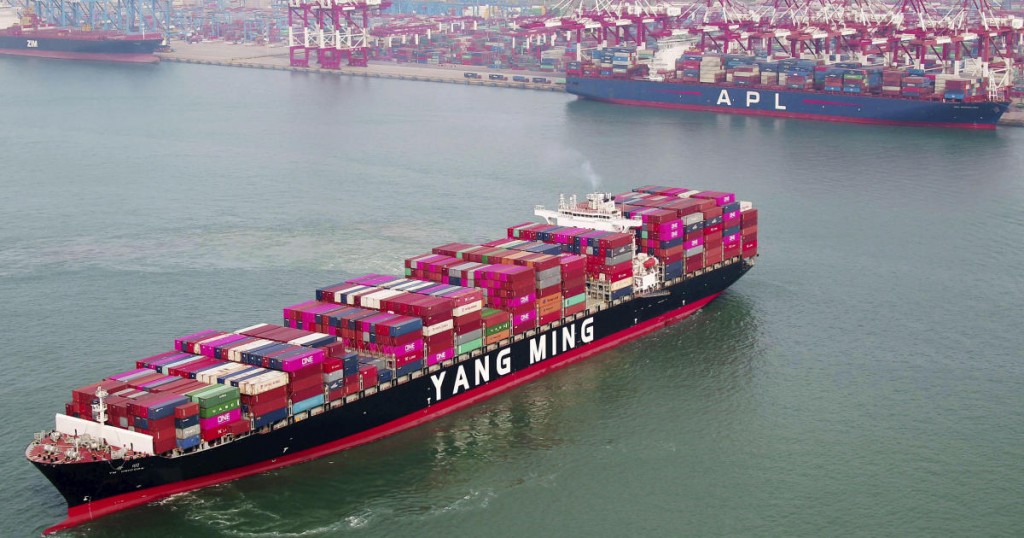 A container ship sails off the dockyard in Qingdao in eastern China's Shandong province Wednesday