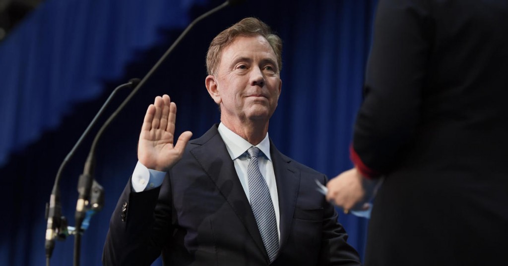 Connecticut Gov. Ned Lamont takes the oath of office administered by former Chief Justice Chase T. Rogers