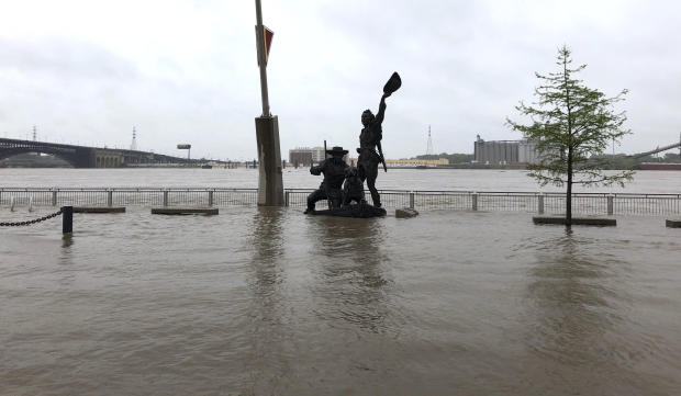 A statue of explorers Lewis and Clark is surrounded by floodwater along the St. Louis riverfront