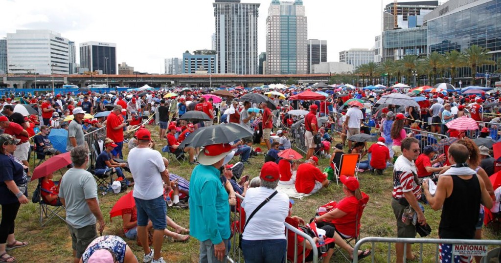 Hundred supporters of US President Donald Trump line up outside the Amway Center on June 18