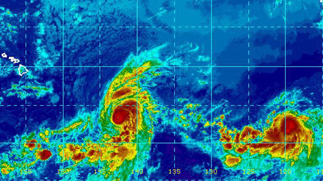 Hurricane Erick, center left, and Tropical Storm Flossie churn in the Pacific Ocean in an infrared satellite image captured at 9 a.m. ET on July 30, 2019. 
