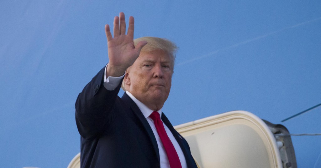 President Donald Trump waves as he boards Air Force One to depart Cleveland-Hopkins International Airport