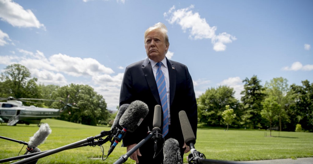 President Donald Trump listens to a question from a member of the media on the South Lawn of the White House in Washington