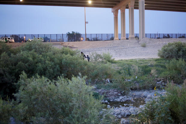 Guatemalan migrant Ledy Perez and her son Anthony cross the Rio Bravo river to enter illegally into the United States after escaping from members of the Mexican National Guard, as seen from Ciudad Juarez