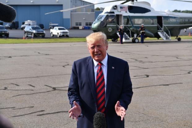 US President Donald Trump speaks to the press before boarding Air Force One in Morristown