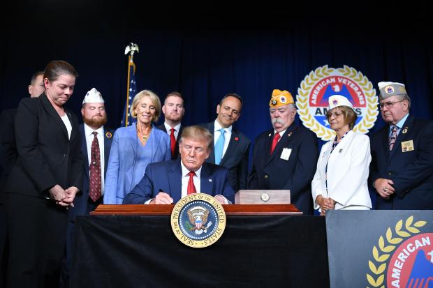 US President Donald Trump sign a Presidential Memorandum on Discharging the Federal Student Loan Debt of Totally and Permanently Disabled Veterans