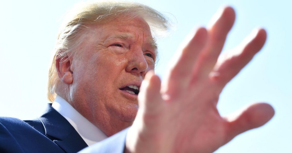 TOPSHOT - US President Donald Trump gestures as he speaks to the press on the South Lawn of the White House before departing in Washington