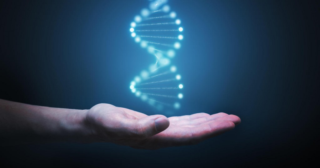 DNA and genetics research concept. Hand is holding glowing DNA molecule in hand.