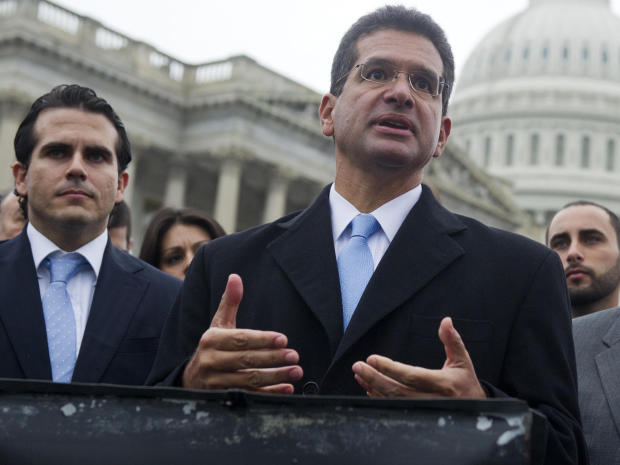 Resident Commissioner Pedro Pierluisi (C) of Puerto Rico speaks alongside US Representative Jose Serrano (R)