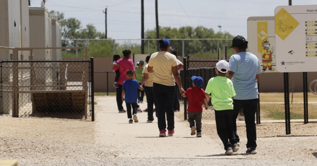 Immigrants seeking asylum leave a cafeteria at the ICE South Texas Family Residential Center