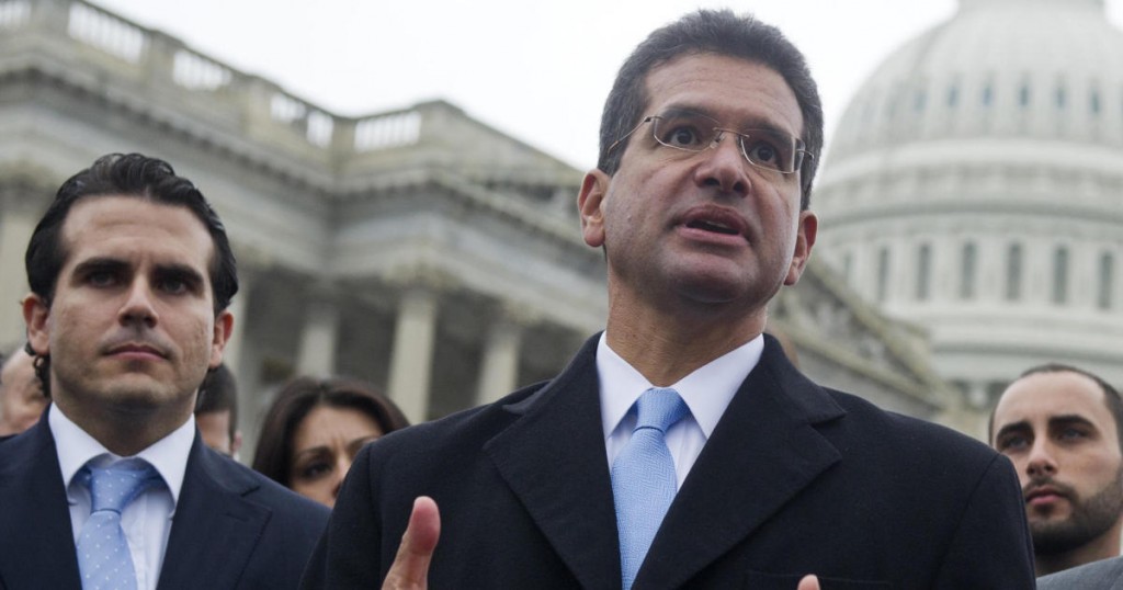 Resident Commissioner Pedro Pierluisi (C) of Puerto Rico speaks alongside US Representative Jose Serrano (R)
