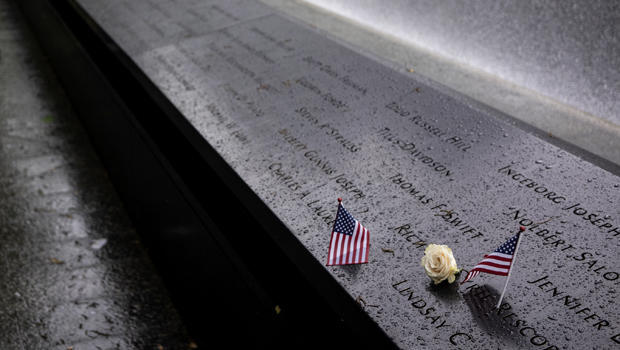 Wind sprays mist over the rim of the South Pool of the 9/11 Memorial Sunday
