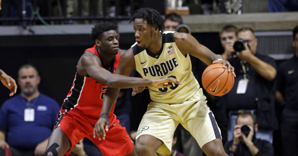 Purdue forward Caleb Swanigan (50) drives on Rutgers forward Candido Sa (21) during the first half of an NCAA college basketball game in West Lafayette
