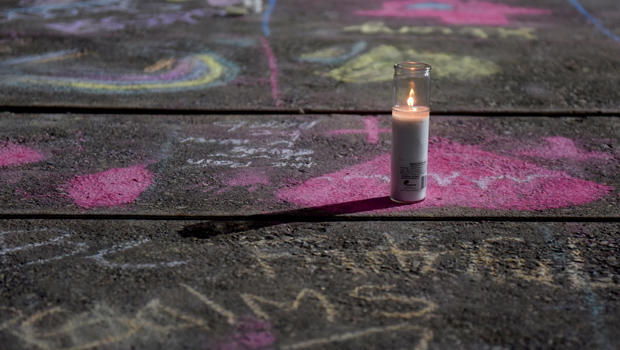 Messages written in sidewalk chalk are seen at the University of Texas of the Permian Basin following Saturday's shooting in Odessa