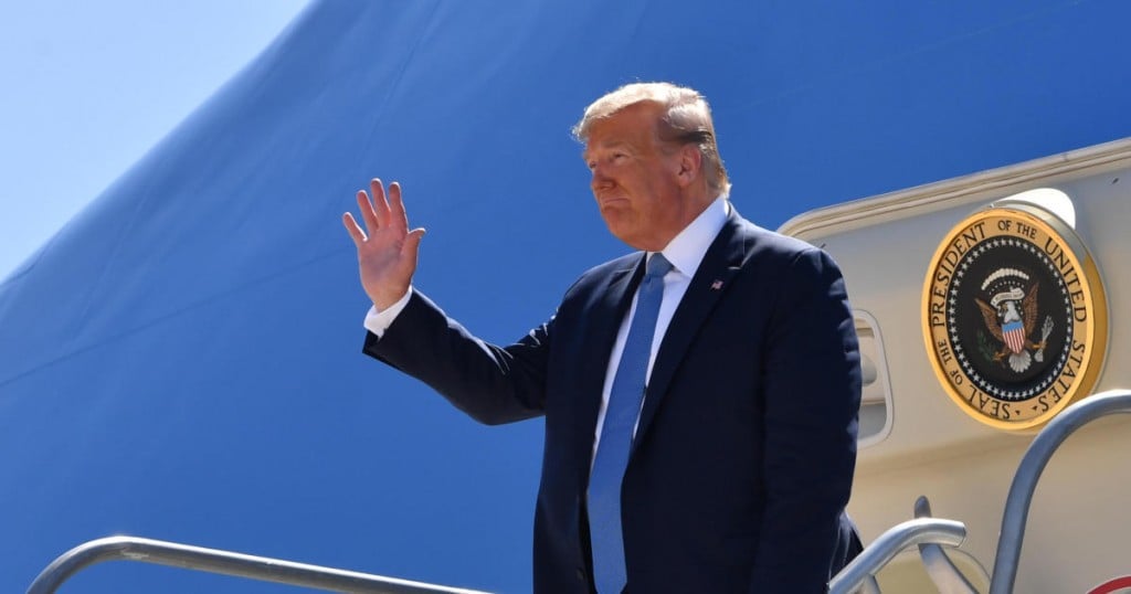 US President Donald Trump waves as he exits Marine One after landing at San Diego International Airport in San Diego