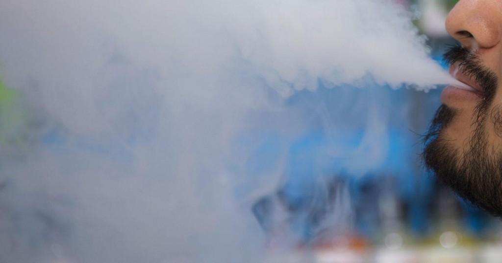 A man smokes an electronic cigarette inside a vape shop in Washington