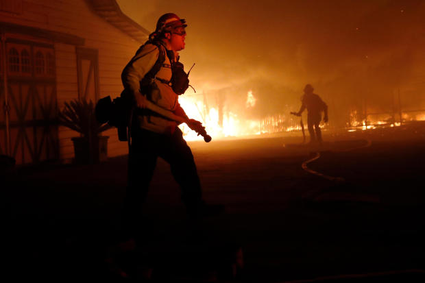 A firefighter gives orders as he battles the wind-driven Kincade Fire in Windsor