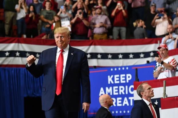 US President Donald Trump gestures as he arrives for a rally at the Monroe Civic Center in Monroe