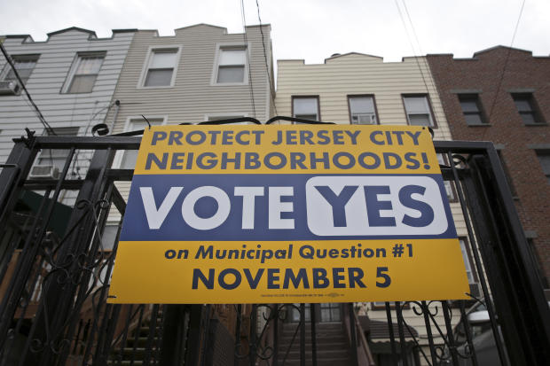A sign urging people to vote on municipal question #1 is displayed in Jersey City