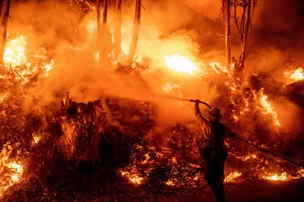 Firefighters work to control flames from a backfire during the Maria Fire in Santa Paula, California, on November 1, 2019. 