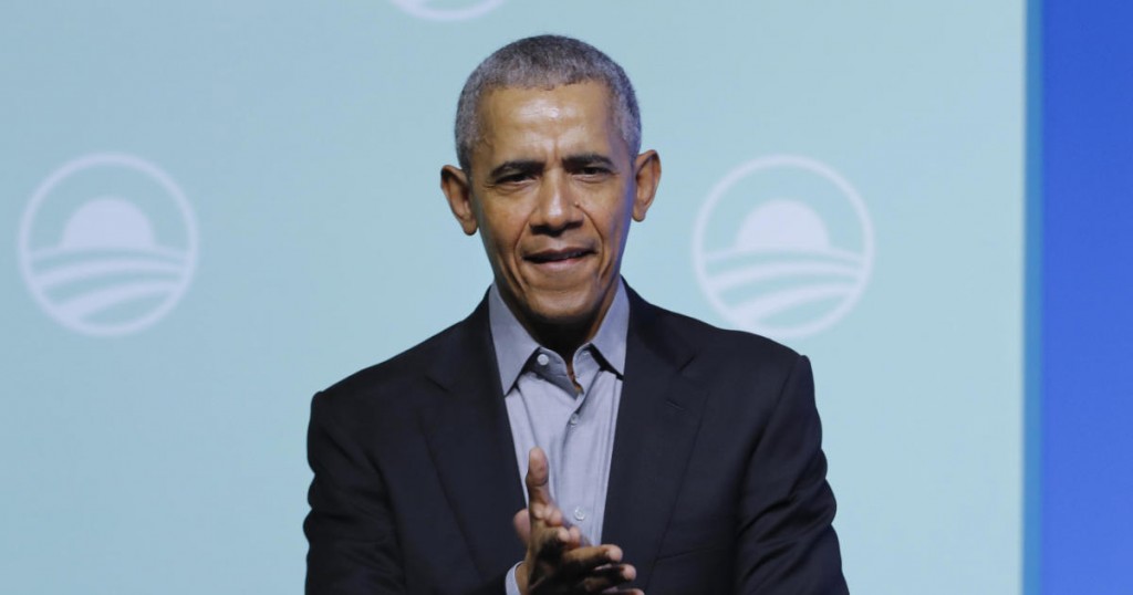 Former U.S. President Barack Obama claps as he arrives for the "values-based leadership" during a plenary session of the Gathering of Rising Leaders in the Asia Pacific