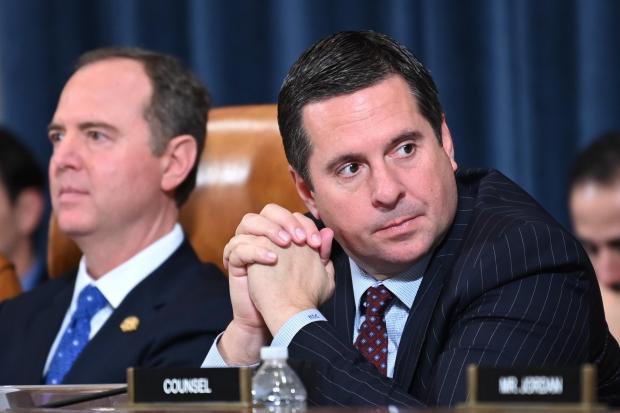 House Intelligence Committee ranking member Rep. Devin Nunes (R) (R-CA) is flanked by Chairman Adam Schiff (D-CA) at a House Intelligence Committee hearing featuring witness US Ambassador to the European Union Gordon Sondland testifying as part of the impeachment inquiry into US President Donald Trump on Capitol Hill in Washington