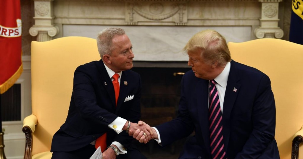 US President Donald Trump(R) shakes hands as he meets with Rep. Jeff Van Drew (D-NJ) in the Oval Office at the White House on December 19