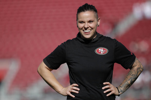 San Francisco 49ers offensive assistant Katie Sowers watches warms up before an NFL football game against the Arizona Cardinals in Santa Clara