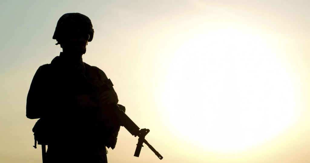 Silhouette of US soldier with rifle against a sunset
