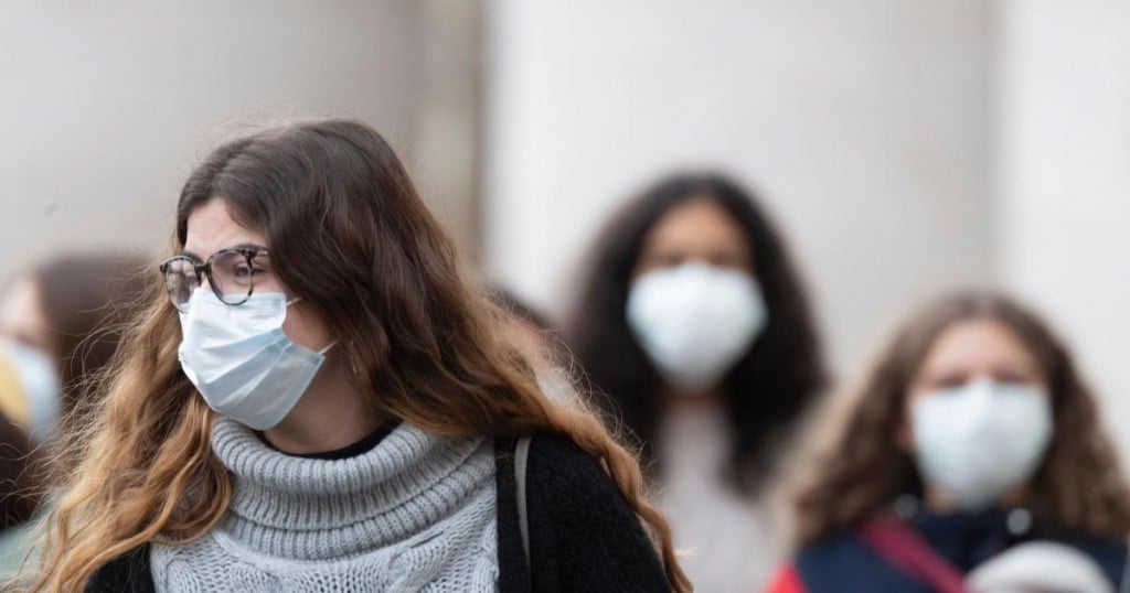 Catholic faithful wear face masks as they arrive in St. Peter's Square at the Vatican for  the weekly general audience on February 26