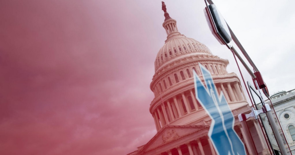 TOPSHOT - A view of the Capitol's Rotunda is seen reflected in an ambulance as negotiations on a COVID-19 economic bailout continue on Capitol Hill March 24
