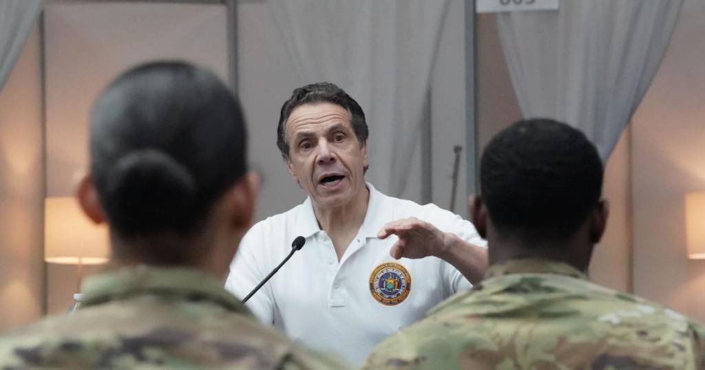National Guard troops listen as New York Governor Andrew Cuomo speaks to the press at the Jacob K. Javits Convention Center in New York