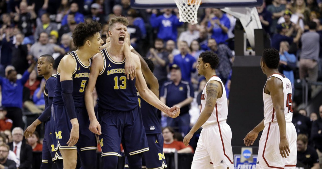 Michigan forwards D.J. Wilson (5) and Moritz Wagner (13) celebrates during the second half of a second-round game against Louisville in the mens NCAA college basketball tournament in Indianapolis