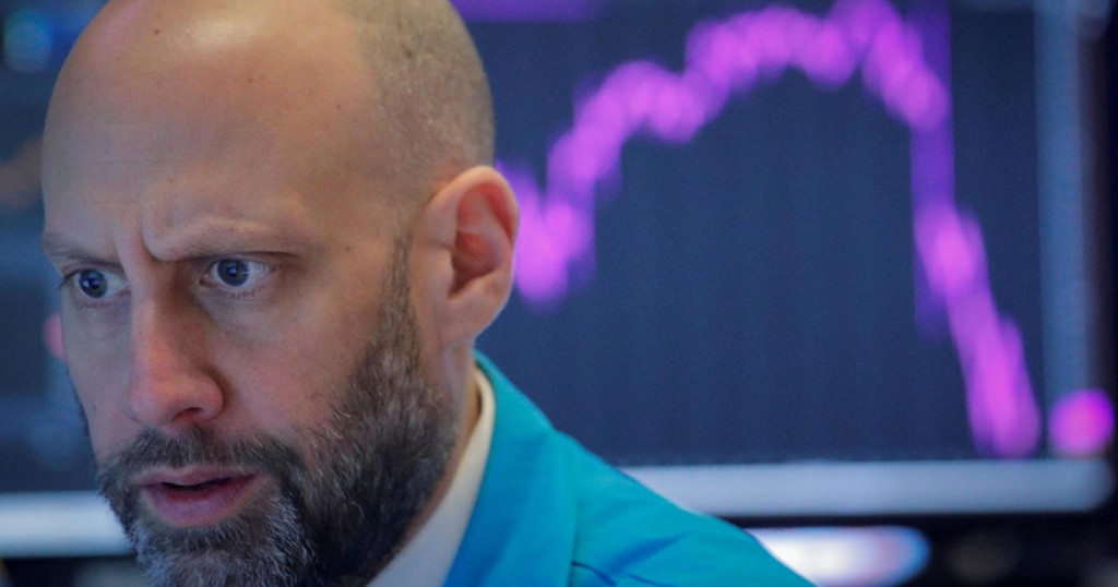 FILE PHOTO: A trader works on the floor of the NYSE on Feb 27