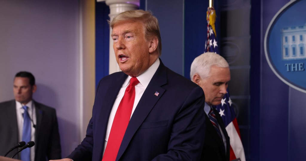 U.S. President Donald Trump is followed by Vice President Mike Pence as he arrives to address the coronavirus task force daily briefing at the White House in Washington