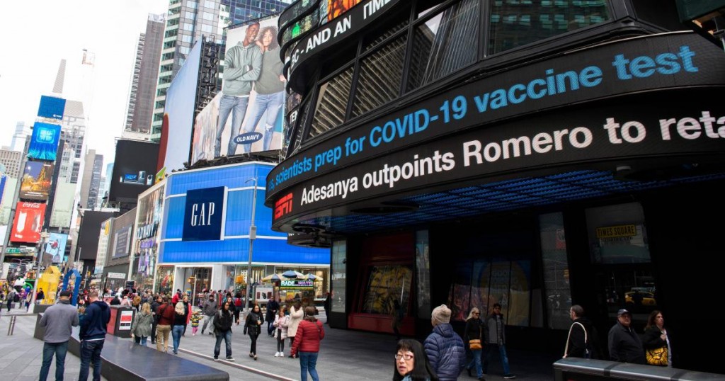 Information related to coronavirus is displayed on a screen in Times Square on March 8