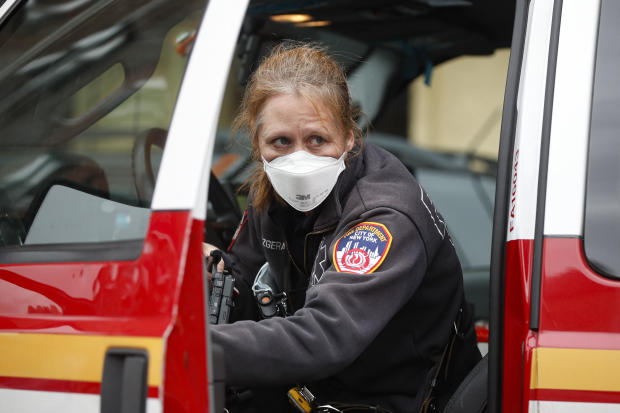 An FDNY medical worker wears personal protective equipment outside a COVID-19 testing site at Elmhurst Hospital Center
