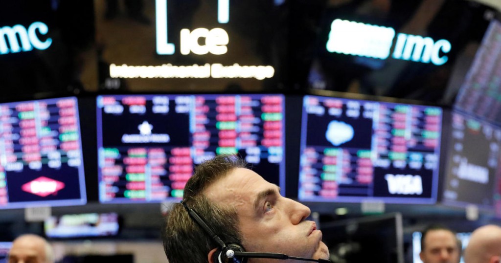 A trader works on the floor of the New York Stock Exchange shortly before the closing bell as the market takes a significant dip in New York