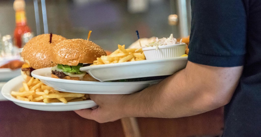 waiter serving fast food in a fast food restaurant