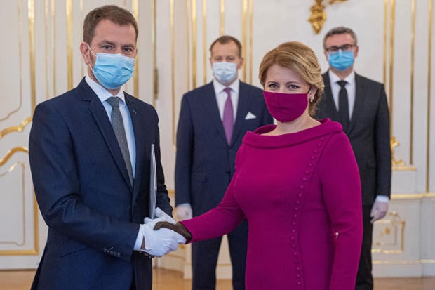 Slovakia's President Zuzana Caputova and Prime Minister Igor Matovic wearing protective face masks attend the cabinet's inauguration at Presidential Palace in Bratislava 