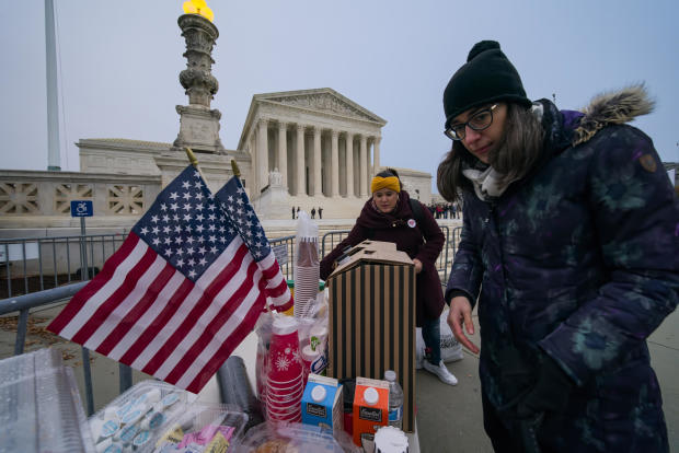 Activists gather outside the Supreme Court before the justices hear arguments in a case brought by gun owners in New York City