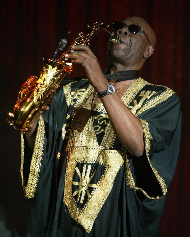 FILE PHOTO: Camoroonese musician Manu Dibango plays his saxaphone during French designer Sorbier's Spring/Summer 2005 high fashion collection in Paris