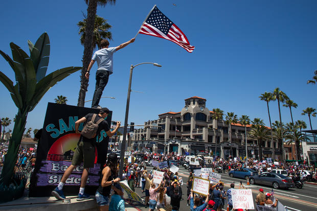 Protest To Reopen California Businesses, Beaches, And Parks Held In Huntington Beach 