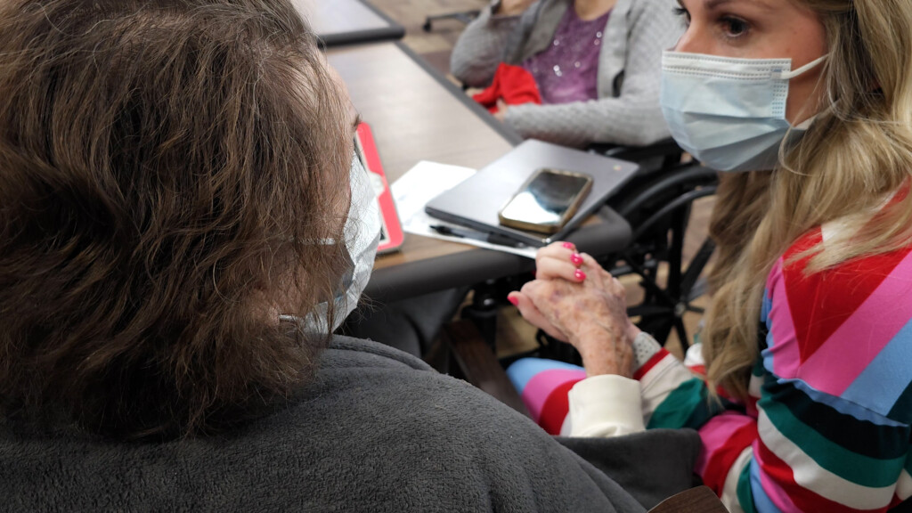 Nurse Holding Elderly Residents Hand