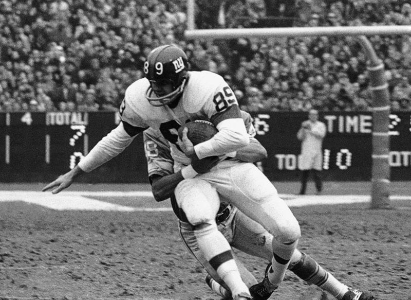 FILE - In this Dec. 10, 1967, file photo, New York Giants' Bob Crespino  (89) is tackled by Detroit Lions' Tom Vaughn (48) after taking a pass from  quarterback Fran Tarkenton for