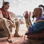 This image released by Disney shows Mena Massoud as Aladdin, left, and Will Smith as Genie in Disney's live-action adaptation of the 1992 animated classic 