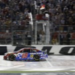 Martin Truex Jr. (19) crosses the finish line to win the NASCAR Cup Series auto race at Charlotte Motor Speedway in Concord, N.C., Sunday, May 26, 2019.