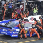 Crew members lift Martin Truex Jr.'s car to change a flat tire during a NASCAR Cup Series auto race at Charlotte Motor Speedway in Concord, N.C., Sunday, May 26, 2019.