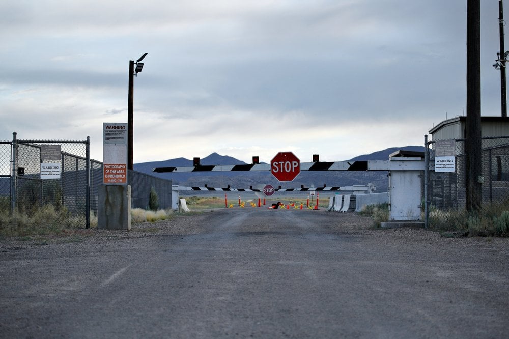 signs warn about trespassing at an entrance to the Nevada Test and Training Range near Area 51 outside of Rachel, Nev.