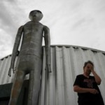 Linda Looney wipes her face outside of the Alien Research Center, a gift shop on the Extraterrestrial Highway, in Crystal Springs, Nev.